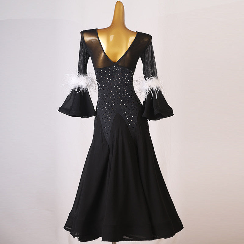 Black ballroom dance dress with scattered rhinestones across the bodice