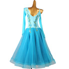 Turquoise ballroom competition dress with the embroidery running to the hip