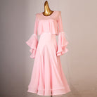 Pink practice dress with the tiered ruffle sleeves lifted to the side