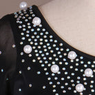 Close up of pearls and rhinestones on the black bodice