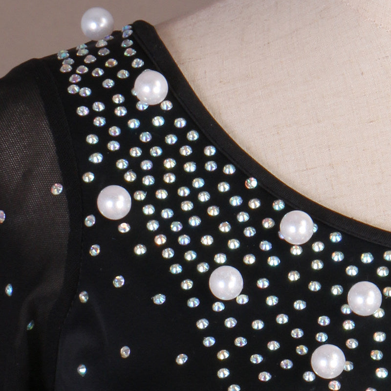 Close up of pearls and rhinestones on the black bodice