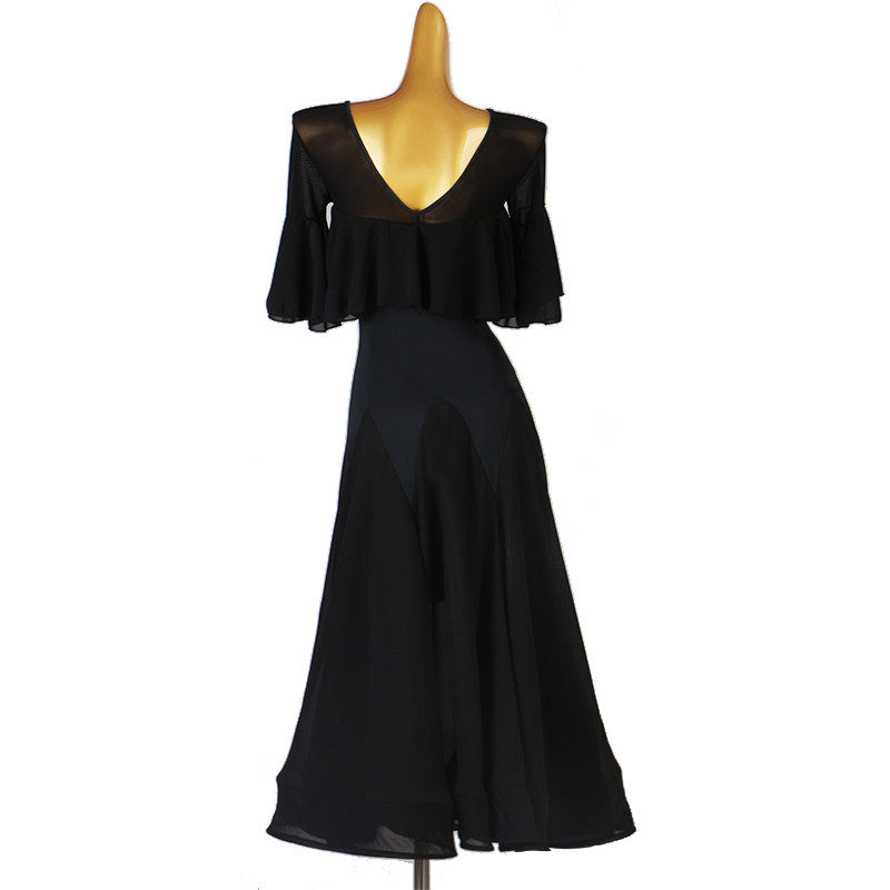 Black ballroom dress with the godet skirt hanging straight on the mannequin