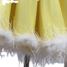 Detail of the white marabou feather band around the yellow chiffon hem