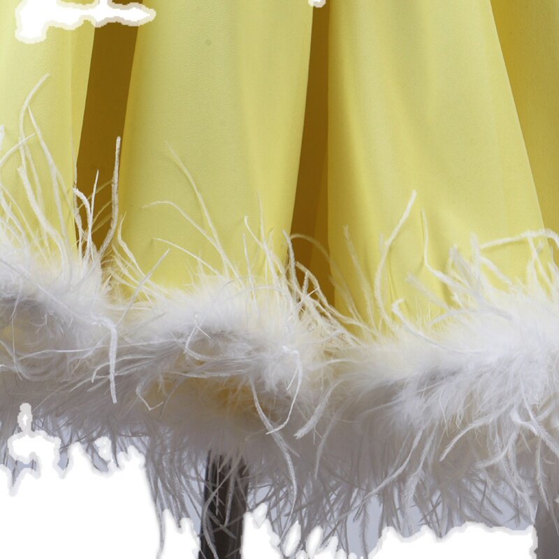 Detail of the white marabou feather band around the yellow chiffon hem