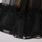 Close up of the gathered ruffle hem on the black mesh skirt