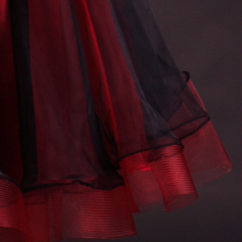 Black and red ballroom gown hem detail showing red layers under black tulle
