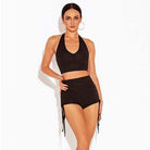 Black high waist dance shorts worn with a halter top, front view