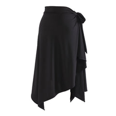 Black wrap Latin dance skirt for salsa practice with side tie and asymmetric handkerchief hem, flat lay