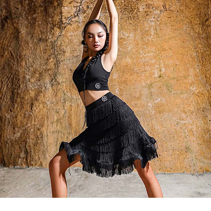 Black tiered fringe Latin dance skirt in a wide dance pose