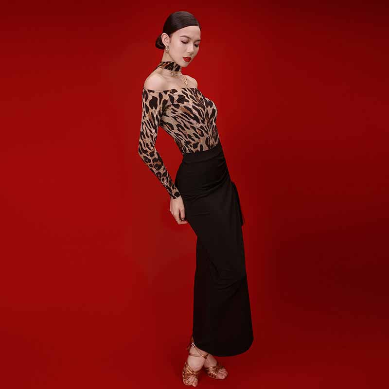 Black wrap Latin dance skirt worn with a leopard top, front view