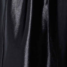 Close view of the black satin fabric and piping