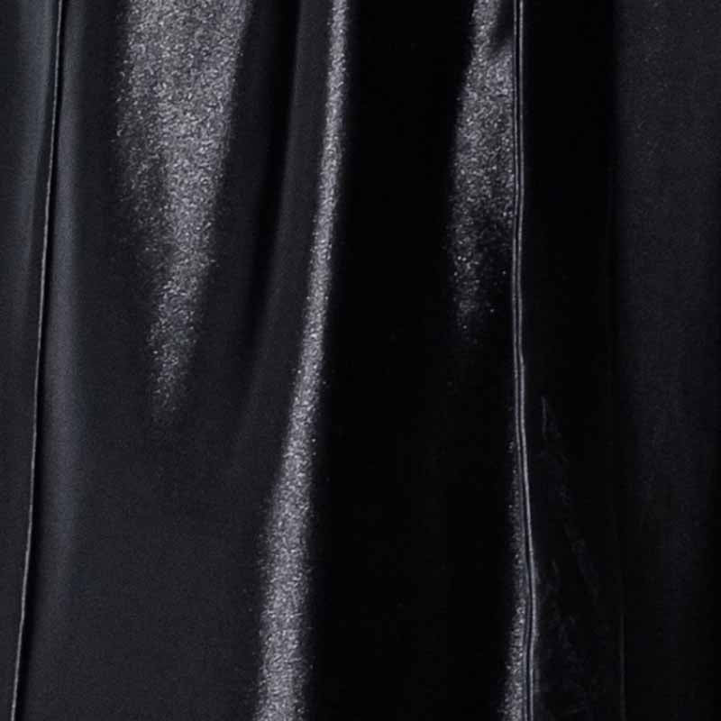 Close view of the black satin fabric and piping