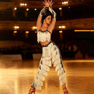 Fringe Latin dance outfit crop top and pants on a ballroom floor