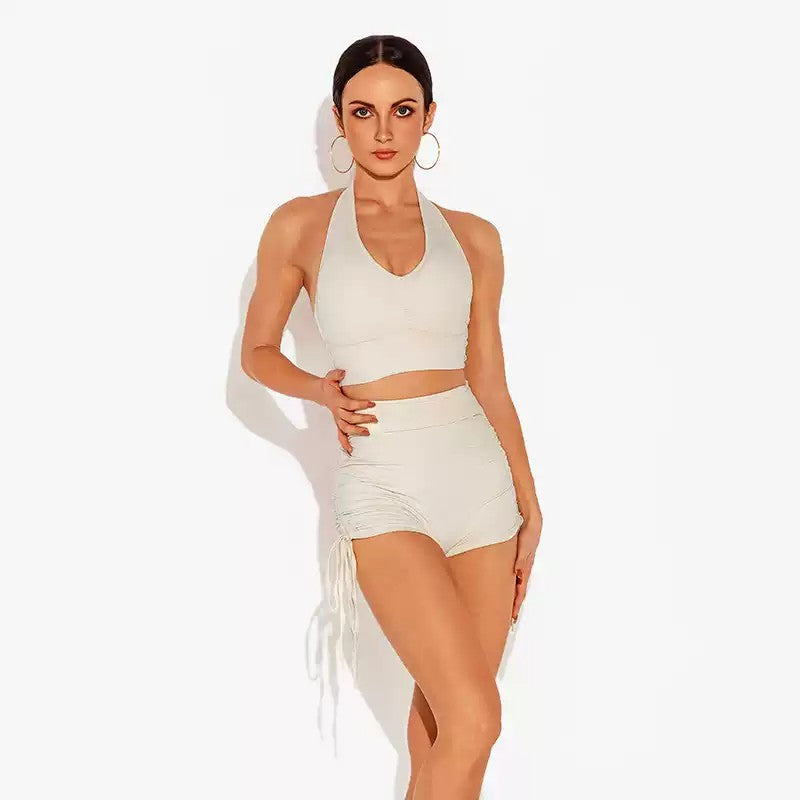 White high waist dance shorts worn with a halter top, front view