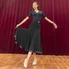 Black button front ballroom leotard worn with a practice skirt