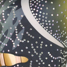 Close-up of rhinestone swirls and the waist cutout