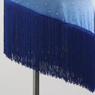 Close-up of the blue fringe on the asymmetric hem