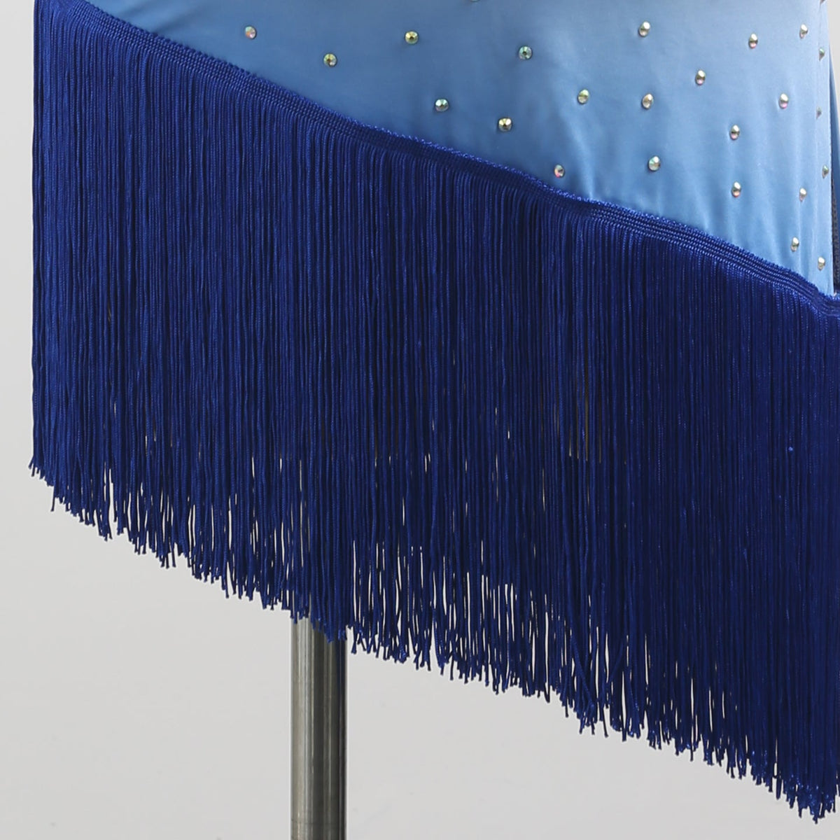 Close-up of the blue fringe on the asymmetric hem