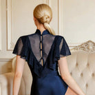 Navy flutter sleeve dance bodysuit, button back view