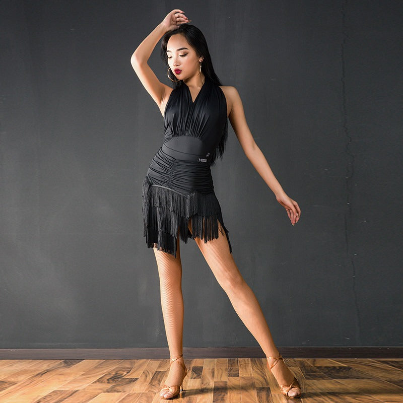 Black halter Latin dance bodysuit worn with a fringe skirt