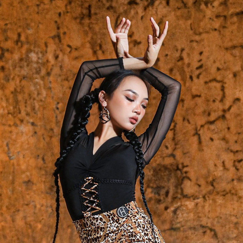 Black long sleeve Latin dance bodysuit, arms raised