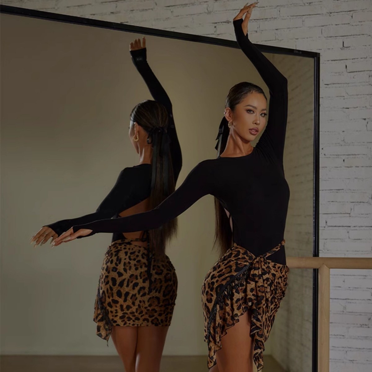 Black long sleeve leotard worn with a leopard wrap skirt