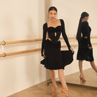 Black velvet bust long sleeve leotard, front view styled with a skirt at the barre