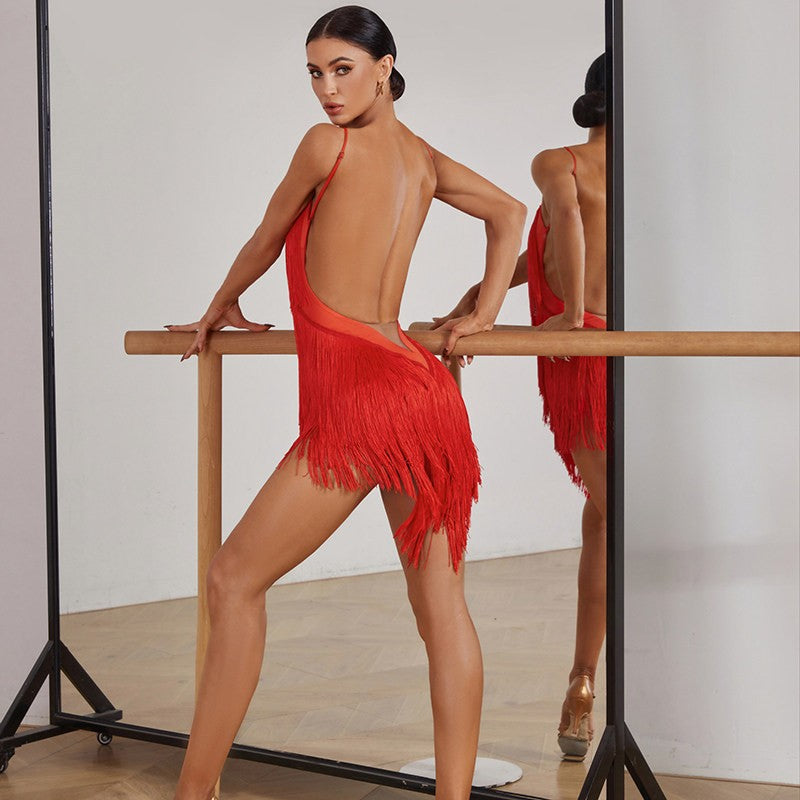Red fringe Latin salsa dance dress, pose at the barre in the mirror