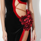 Red rosette and crossed strap cutout on a velvet dance dress, close up