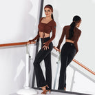 Black flared dancesport practice trousers worn at the barre