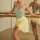 Yellow ribbon fringe dance wrap skirt for salsa practice, front view at the barre