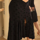 Black polka dot skirt, close-up of the polka dot fabric and front slit
