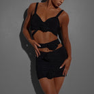 Black ruched rosette Latin dance mini skirt for salsa practice, waist-down front view