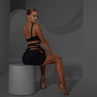Black ruched rosette mini skirt, side view seated