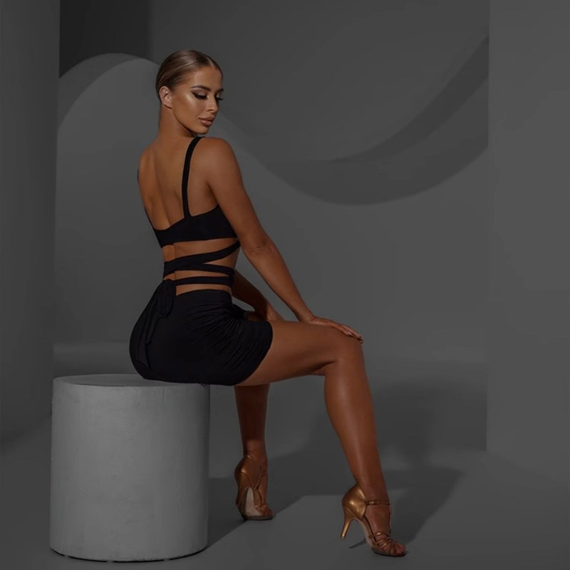 Black ruched rosette mini skirt, side view seated