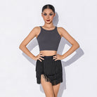 Grey racerback crop dance top worn with a fringe skirt