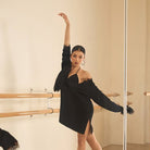 Black oversized long sleeve tunic top, side view with arm raised