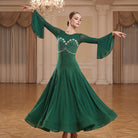 Green ballroom dress worn by a dancer in a ballroom, full length front view