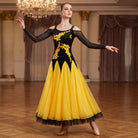 Yellow ballroom dress worn by a dancer in a ballroom, full length front view
