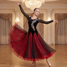 Black-Red ballroom dress worn by a dancer in a ballroom, full length front view