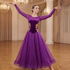 Purple ballroom dress worn by a dancer in a ballroom, full length front view