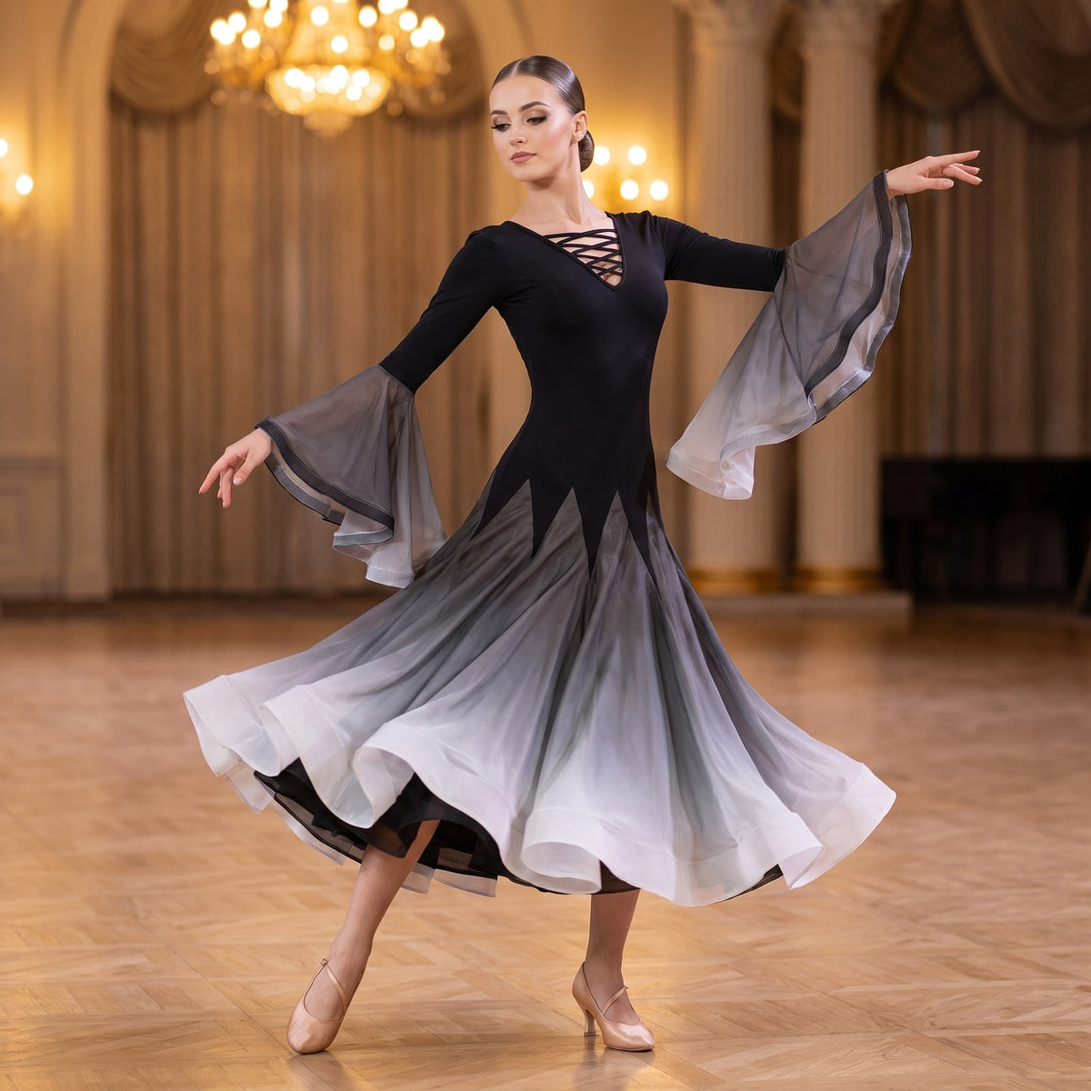Black to grey ombre ballroom dress with a laced V neck and bell sleeves in a ballroom