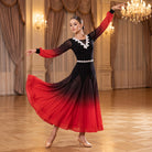 Black to red ombre ballroom dress with lace trim at the V neckline sweeping across a ballroom