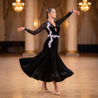 Black velvet ballroom dance dress with a white applique swirl and V neckline