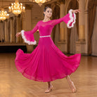 Hot pink ballroom dance dress with white feather cuffs and a rhinestone waistband