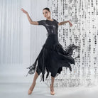 Dancer in the black handkerchief hem ballroom skirt with the pointed panels flying out