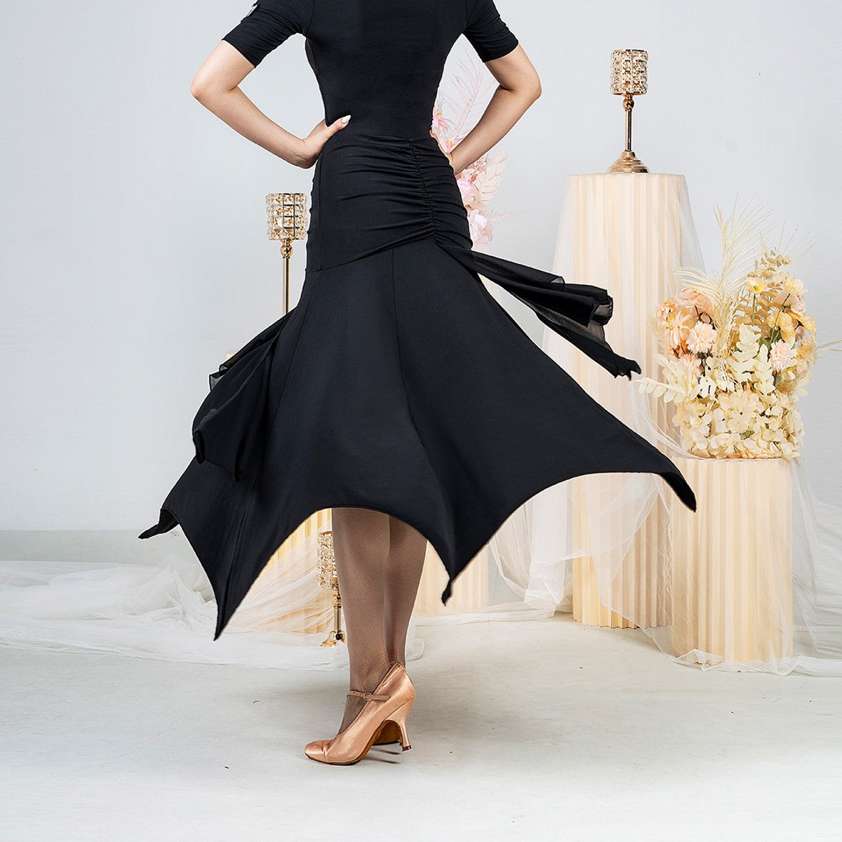 Black ballroom practice skirt with ruched hip yoke and pointed handkerchief hem, back view