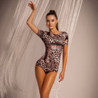 Dancer wearing the TTdancewear leopard print scoop open back Latin dance leotard bodysuit
