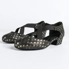 Black ballroom dance shoes pair with metallic gold peacock-eye print, closed round toe and crossed elastic straps on a low block heel
