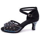 Black satin latin dance shoes side view, mesh vamp with an aurora borealis rhinestone starburst, crystal faced flared heel and crossed ankle strap